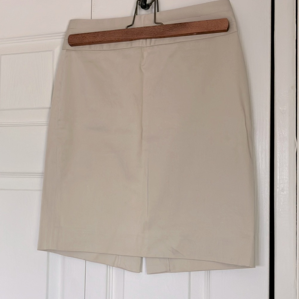 Tan mid length skirt with rear zip and slit and wide waist band